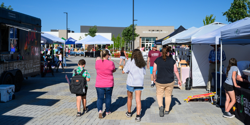 Photo of people walking through a market